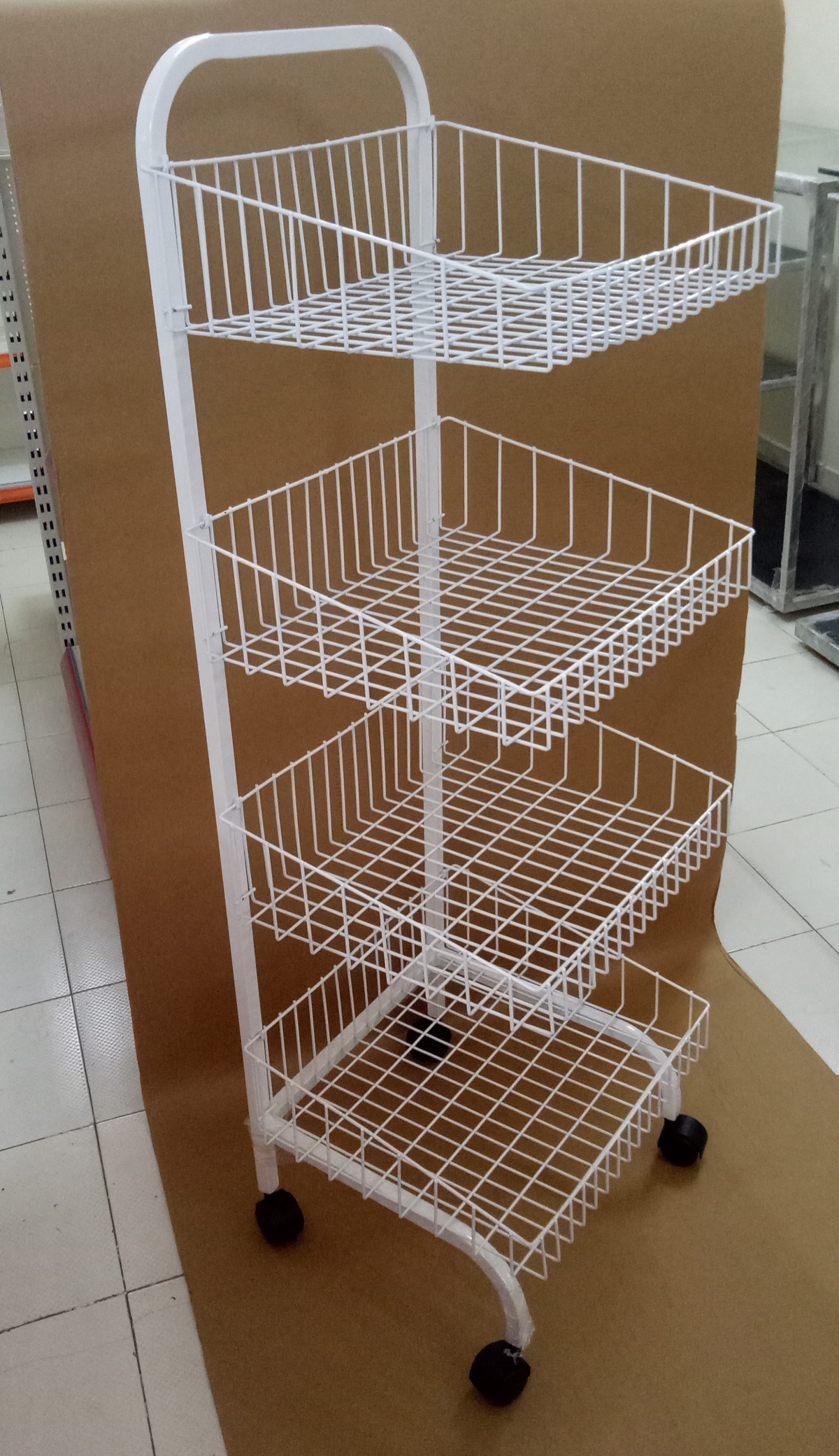 Wire display rack with several baskets for bakery products.